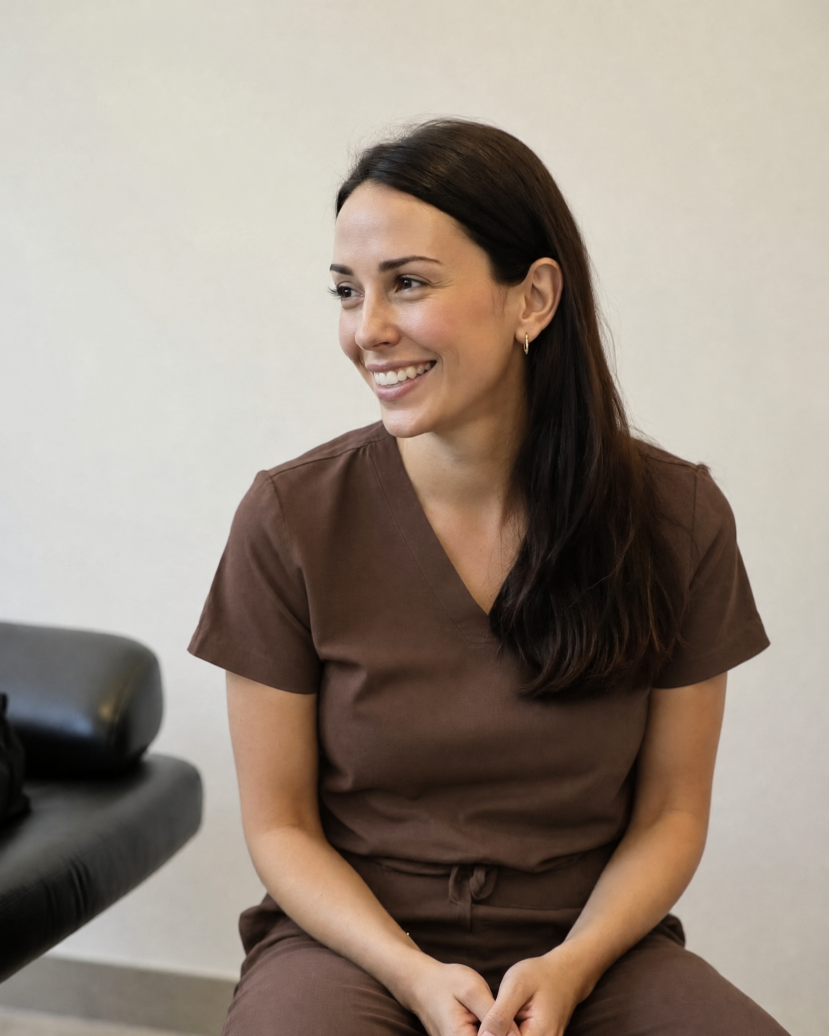 Mia Thomas, Nurse Practitioner, in brown scrubs at the Woollahra treatment room
